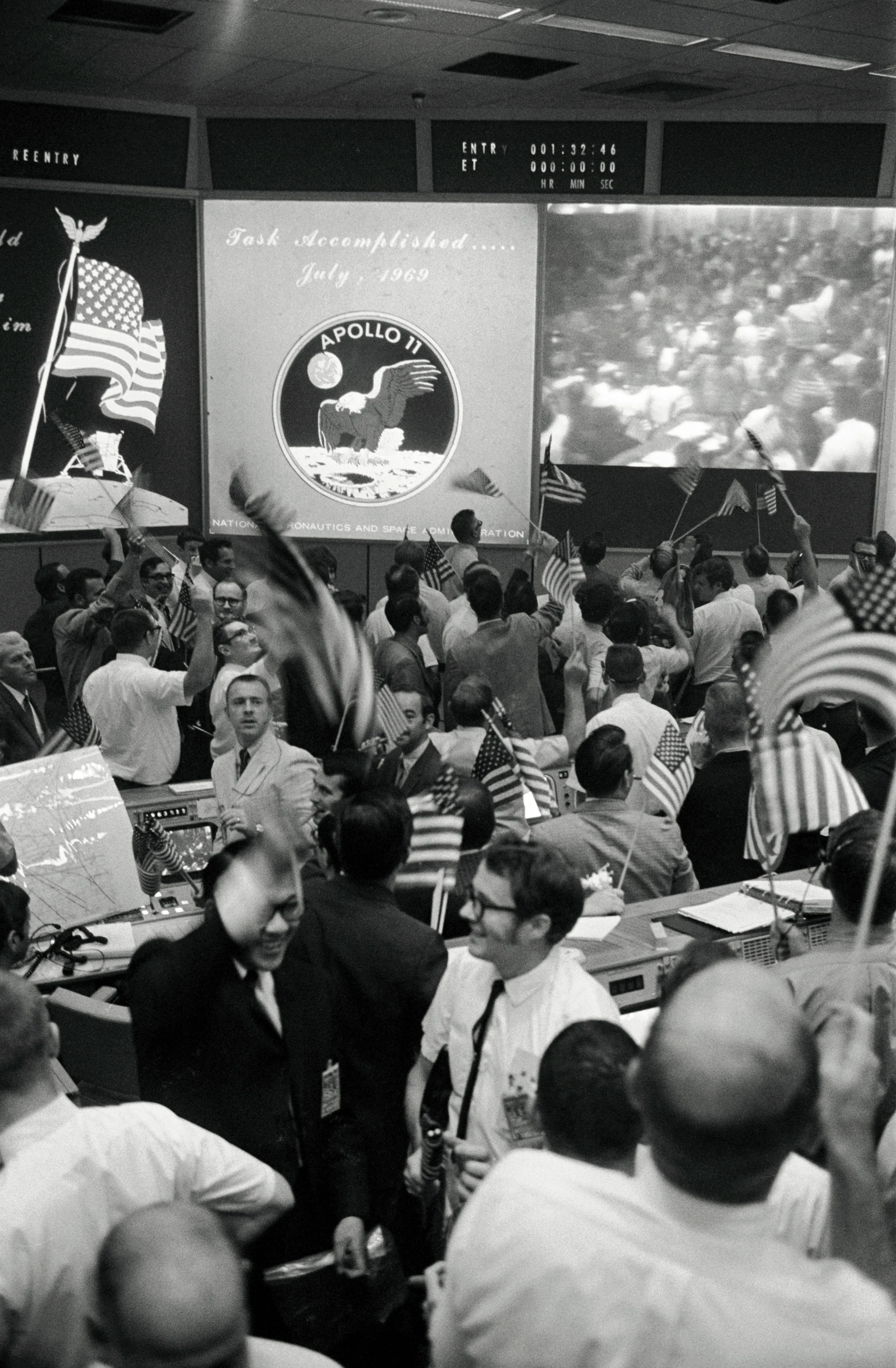 NASA Mission Control in Houston erupts in celebration as Apollo 11 confirms lunar landing, July 1969.